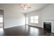 Open-concept living area with hardwood floors, fireplace, and ample natural light from the windows and door at 1030 Gardenia Dr # 2, Mt Ulla, NC 28125