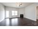 Bright living room featuring dark hardwood floors, fireplace, fan and a door to the backyard at 1030 Gardenia Dr # 2, Mt Ulla, NC 28125