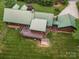 Aerial view of the log cabin home showing the expansive yard, deck, and lush landscaping at 10583 Earnhardt Lake Rd, Davidson, NC 28036