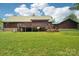 Rear view of the log home showing the spacious yard, deck, and exterior details at 10583 Earnhardt Lake Rd, Davidson, NC 28036