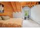 Comfortable bedroom with wood panels, a bed, desk, and natural light from the window at 10583 Earnhardt Lake Rd, Davidson, NC 28036