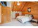 Inviting bedroom featuring a vaulted ceiling, cozy bed, dresser and art on the wall at 10583 Earnhardt Lake Rd, Davidson, NC 28036