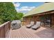 Spacious wooden deck with grill, two lounge chairs, and access to the home at 10583 Earnhardt Lake Rd, Davidson, NC 28036
