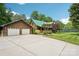 Expansive driveway leading to a charming log home with a matching detached two-car garage at 10583 Earnhardt Lake Rd, Davidson, NC 28036