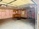 Functional garage with a workbench, storage cabinets, utility door, and insulated walls at 10583 Earnhardt Lake Rd, Davidson, NC 28036