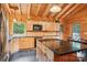 Warm, wood-finished kitchen with black countertops and stainless-steel appliances at 10583 Earnhardt Lake Rd, Davidson, NC 28036