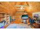 Bright living room with pitched ceiling, wood panels and desk with two monitors at 10583 Earnhardt Lake Rd, Davidson, NC 28036