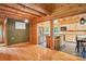 Inviting log cabin living room featuring hardwood floors and open kitchen area at 10583 Earnhardt Lake Rd, Davidson, NC 28036