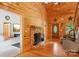 Charming living room featuring a stone fireplace, wood floors, and a decorative front door at 10583 Earnhardt Lake Rd, Davidson, NC 28036