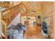 Relaxing log cabin living space with staircase, stone fireplace, and view to kitchen at 10583 Earnhardt Lake Rd, Davidson, NC 28036