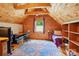 Spacious room with wood panels, desk and bed at 10583 Earnhardt Lake Rd, Davidson, NC 28036