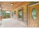 Charming porch featuring a rustic wooden door, window, and decorative wreath at 10583 Earnhardt Lake Rd, Davidson, NC 28036