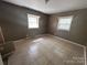 Bedroom with tile flooring, two windows and neutral walls at 10625 Cool Springs Rd, Woodleaf, NC 27054