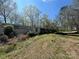 Shot of the home's exterior featuring a trailer and lush surrounding trees at 10625 Cool Springs Rd, Woodleaf, NC 27054