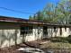 This exterior of this building features stucco walls, and multiple windows with green trim at 10625 Cool Springs Rd, Woodleaf, NC 27054