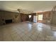 Interior view of living room with brick fireplace, ceiling fan and tile flooring at 10625 Cool Springs Rd, Woodleaf, NC 27054