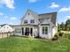 Expansive backyard featuring a covered patio area perfect for outdoor relaxation and entertainment at 11015 Benjamin Smith Ave, Huntersville, NC 28078