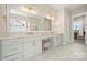 Bright bathroom with double vanity, modern fixtures, and marble tile at 11015 Benjamin Smith Ave, Huntersville, NC 28078