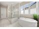 Bathroom with a soaking tub, large shower with glass door and marble tile at 11015 Benjamin Smith Ave, Huntersville, NC 28078