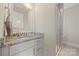 A well-lit bathroom vanity features granite countertop and brushed nickel fixtures at 11015 Benjamin Smith Ave, Huntersville, NC 28078