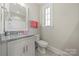 A bathroom features a brushed nickel faucet, and a toilet next to the vanity at 11015 Benjamin Smith Ave, Huntersville, NC 28078