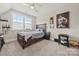 This bedroom features carpet, a ceiling fan, and a window allowing for plenty of natural light at 11015 Benjamin Smith Ave, Huntersville, NC 28078