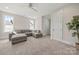 This bedroom features carpet, two windows, and a gray sectional couch at 11015 Benjamin Smith Ave, Huntersville, NC 28078