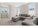 The bedroom features carpet, three windows, and a gray sectional couch at 11015 Benjamin Smith Ave, Huntersville, NC 28078