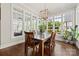Bright dining room featuring hardwood floors, a modern chandelier and many windows with a view of the backyard at 11015 Benjamin Smith Ave, Huntersville, NC 28078