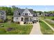 Charming home with a welcoming front porch, lush landscaping, and a spacious driveway at 11015 Benjamin Smith Ave, Huntersville, NC 28078