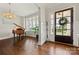 Elegant foyer with hardwood floors, a grand piano, and a view to the front door at 11015 Benjamin Smith Ave, Huntersville, NC 28078