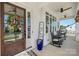 Charming front porch with a wreath-adorned door, ceiling fans, and cozy seating area at 11015 Benjamin Smith Ave, Huntersville, NC 28078