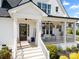 Inviting front porch with comfortable seating, decorative plants, and a welcoming entryway at 11015 Benjamin Smith Ave, Huntersville, NC 28078