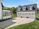 Spacious three-car garage with ample parking and a well-maintained driveway and manicured lawn at 11015 Benjamin Smith Ave, Huntersville, NC 28078
