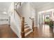 Hallway featuring hardwood floors, staircase, and an entryway to the main living spaces at 11015 Benjamin Smith Ave, Huntersville, NC 28078