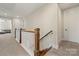 Bright hallway with carpeted floors, wooden railing and several doors at 11015 Benjamin Smith Ave, Huntersville, NC 28078