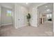 The hallway has carpet, a plant in a basket, doors, and a window at 11015 Benjamin Smith Ave, Huntersville, NC 28078