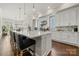 Bright kitchen island with bar seating and a view of the backyard at 11015 Benjamin Smith Ave, Huntersville, NC 28078