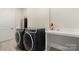 Functional laundry room with modern washer and dryer, utility sink and ample storage at 11015 Benjamin Smith Ave, Huntersville, NC 28078