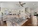 Cozy living room with a large sectional sofa, a fireplace, and hardwood floors at 11015 Benjamin Smith Ave, Huntersville, NC 28078