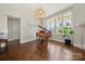 Elegant living room with hardwood floors, a chandelier, and a grand piano at 11015 Benjamin Smith Ave, Huntersville, NC 28078
