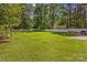 Expansive backyard with a well-maintained lawn and privacy fence at 130 Overcreek Rd, Mooresville, NC 28117