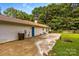 Side of house with a concrete patio and additional backyard space at 130 Overcreek Rd, Mooresville, NC 28117