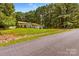 Charming single-story home with lush green lawn and mature trees providing shade and curb appeal at 130 Overcreek Rd, Mooresville, NC 28117