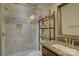 Modern bathroom showcasing a glass-enclosed shower, granite countertop, and stylish storage shelves at 1306 Kings Bottom Dr, Fort Mill, SC 29715