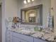 Charming bathroom with a decorative mirror, granite countertop and neutral color scheme at 1306 Kings Bottom Dr, Fort Mill, SC 29715