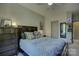 Cozy bedroom featuring a bed with gray and yellow accents, complemented by dresser and mirror at 1306 Kings Bottom Dr, Fort Mill, SC 29715