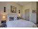 A quaint bedroom features a Queen sized bed, warm neutral paint and cozy lighting at 1306 Kings Bottom Dr, Fort Mill, SC 29715