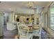 Open dining room showcasing hardwood floors and seamless flow into the living room and modern kitchen at 1306 Kings Bottom Dr, Fort Mill, SC 29715