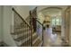 Elegant foyer with hardwood floors, a staircase, and arched doorway leading to the living room fireplace at 1306 Kings Bottom Dr, Fort Mill, SC 29715